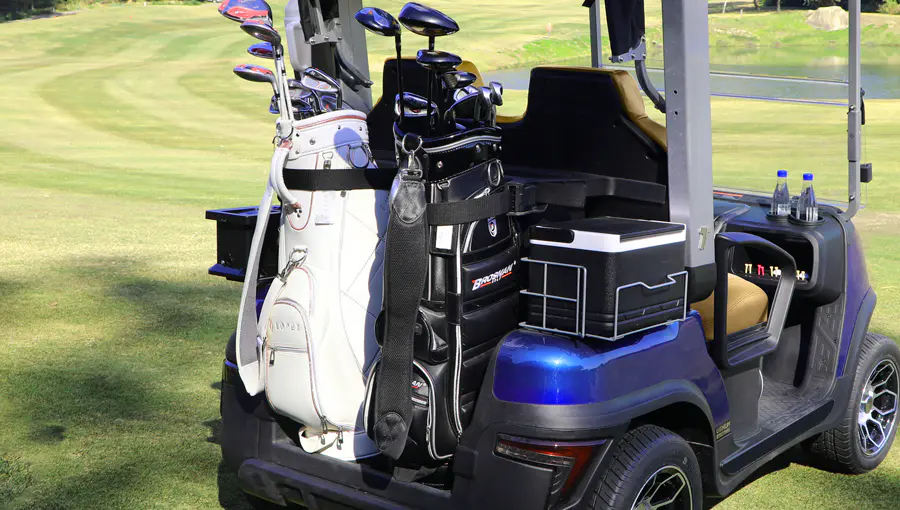 Rear view of Tara Spirit Plus golf cart showing multiple accessories including storage compartments and holders