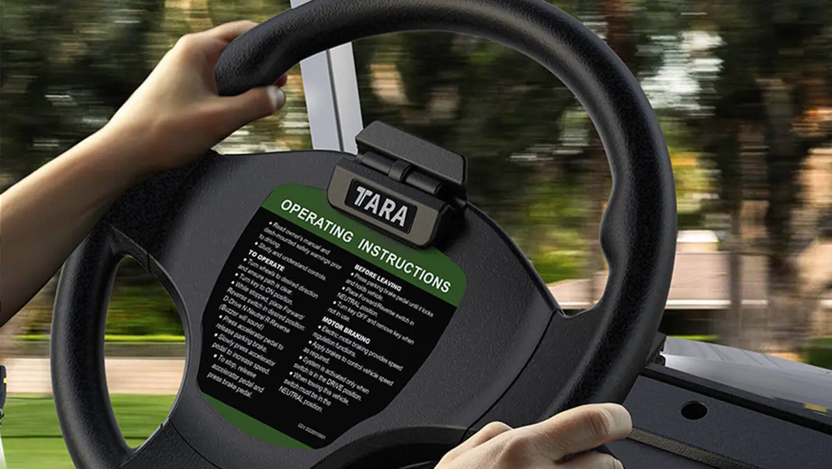 Scorecard holder mounted on steering wheel of Tara golf cart